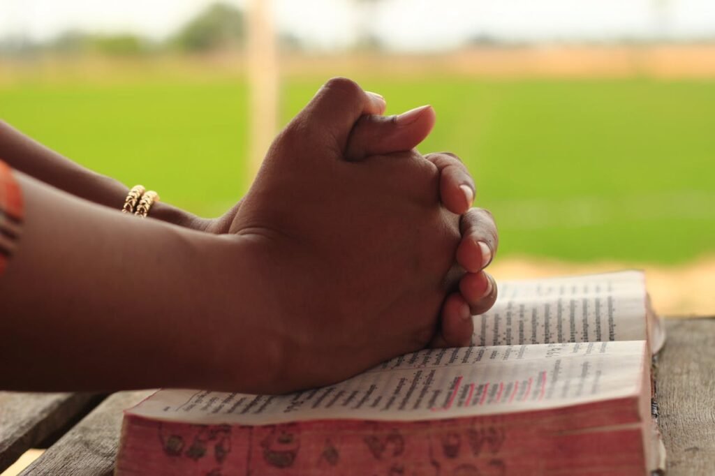 Close Up Shot of Human Hands on the Book